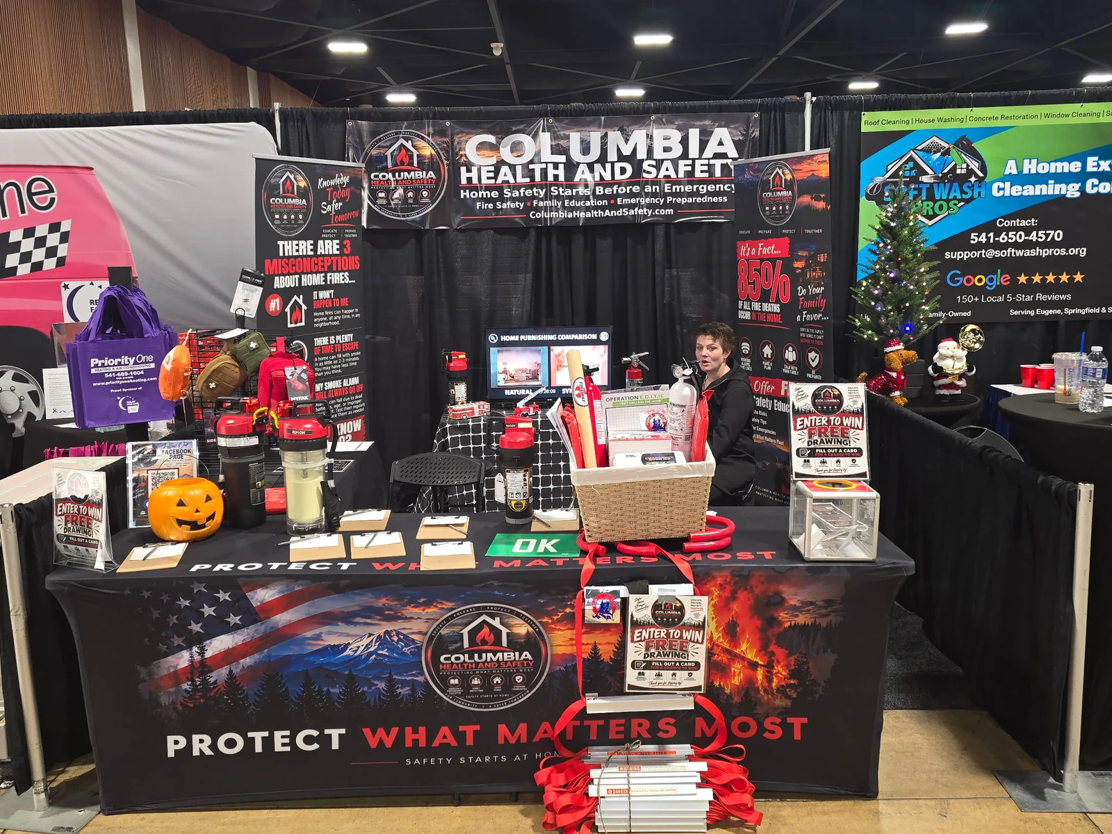Community & Events Columbia Health & Safety booth displaying branded banners, fire extinguishers, emergency supplies, and home safety materials in Eugene, Oregon, October 2026.